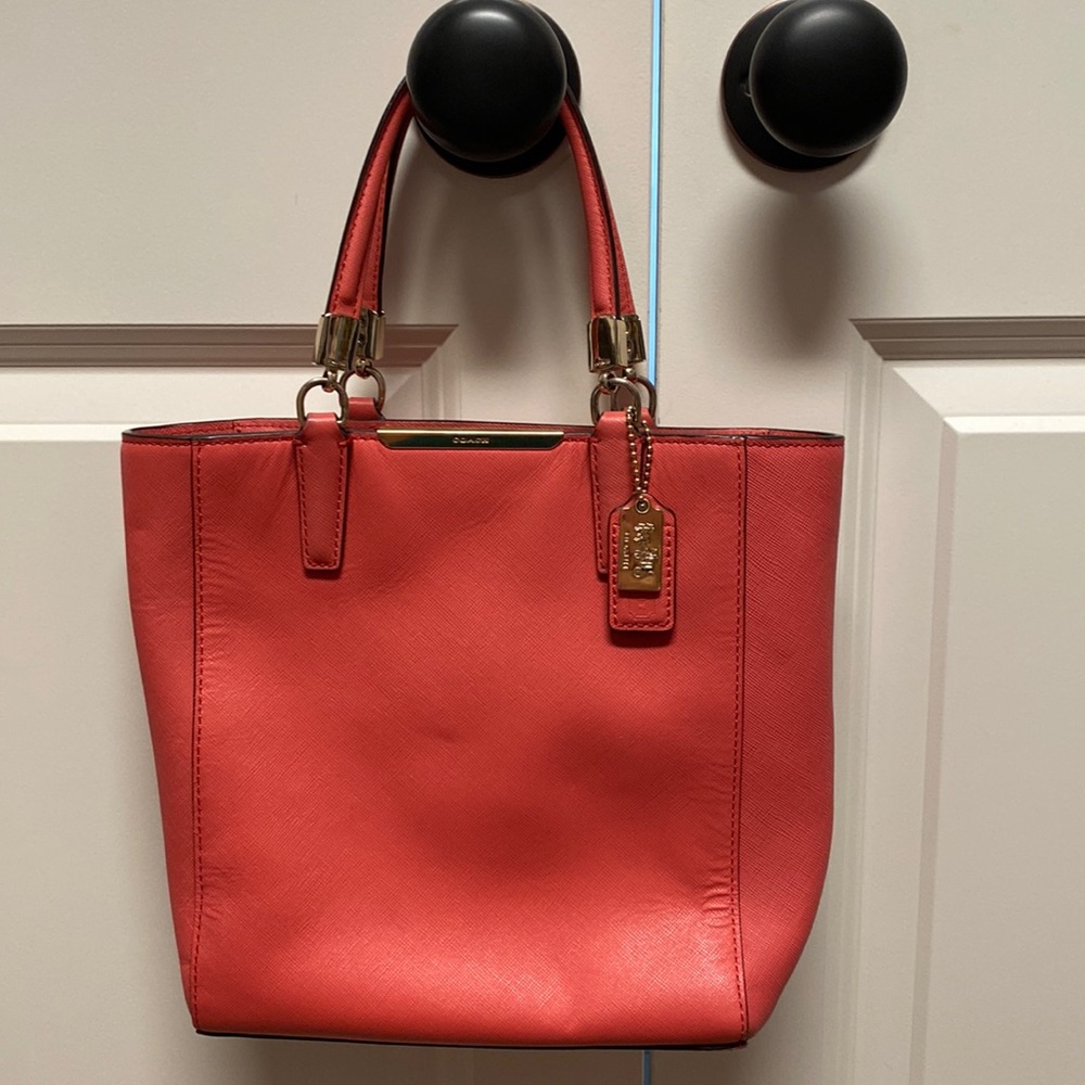 Coach purse with cross body strap option. Salmon colored, used, GREAT condition